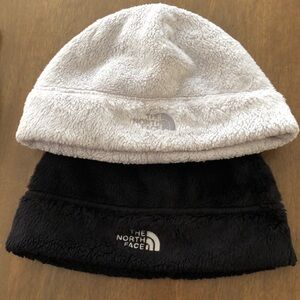 One cream and one black North Face beanie.